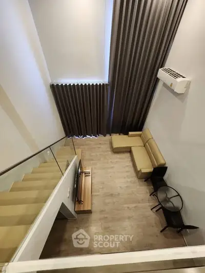 Modern loft-style living room with high ceilings and stylish furniture