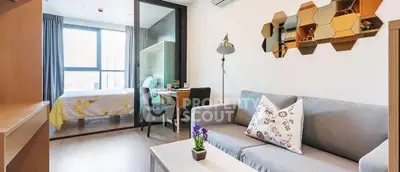 Modern open-plan living room with stylish decor and cozy bedroom view