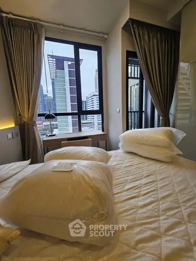 Luxurious bedroom with city view, featuring elegant curtains and plush bedding, perfect for urban living.