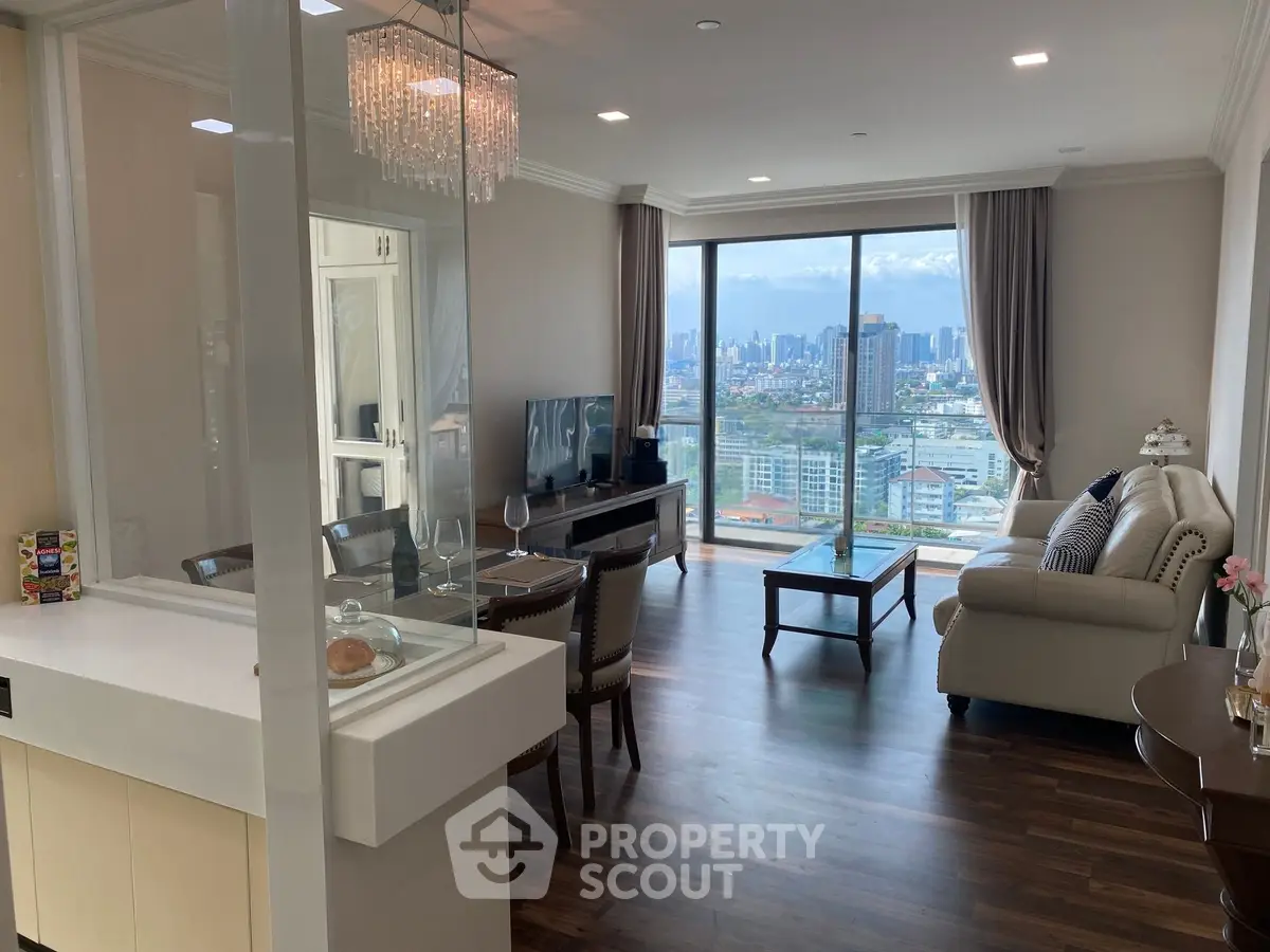 Luxurious living room with stunning city view, elegant decor, and modern furnishings in high-rise apartment.