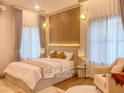 Luxurious bedroom with elegant decor and soft lighting, featuring a cozy bed and stylish furnishings.