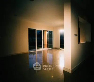 Spacious empty living room with large windows and glossy floors, perfect for customization.