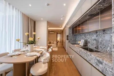 Luxurious open-plan kitchen and dining area with elegant decor and modern appliances.