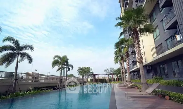 Luxurious apartment complex with stunning pool and palm trees