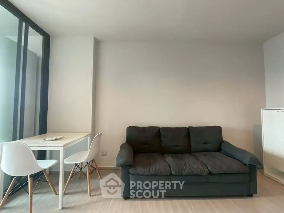 Modern living room with cozy sofa and dining area in a stylish apartment.