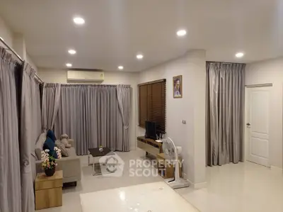 Spacious living room with modern decor and ample natural light