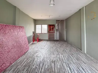 Spacious unfurnished room with modern flooring and natural light, ideal for customization.