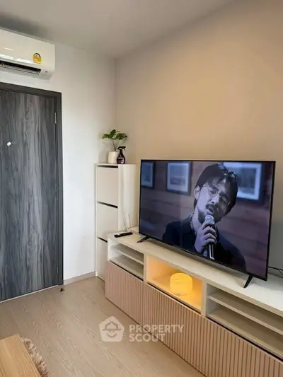 Modern living room with sleek TV setup and stylish storage solutions.