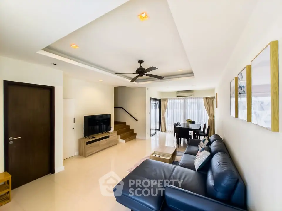 Spacious living room with modern decor and large leather sofa
