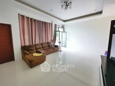 Spacious living room with modern sofa and large windows for natural light
