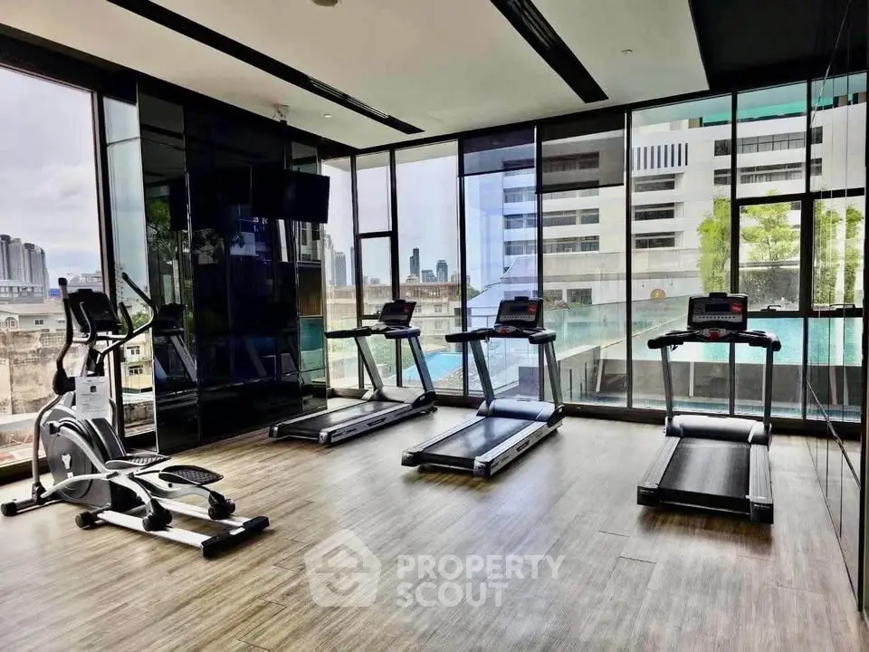 Modern gym with city view in luxury apartment building