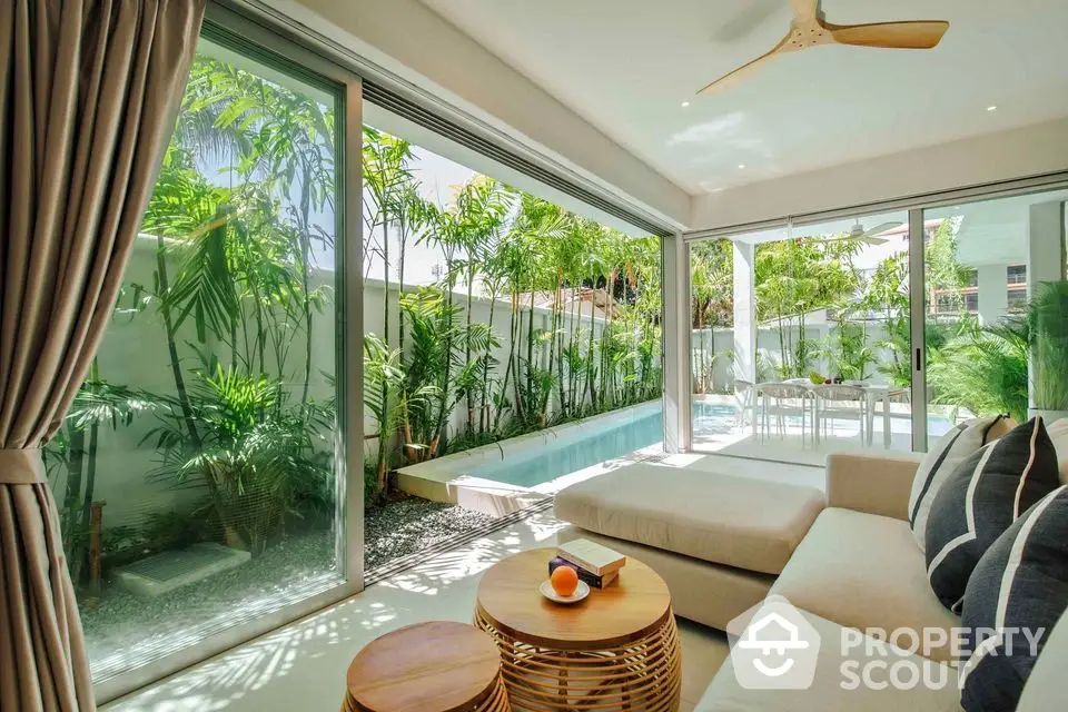 Luxurious living room with pool view and modern decor