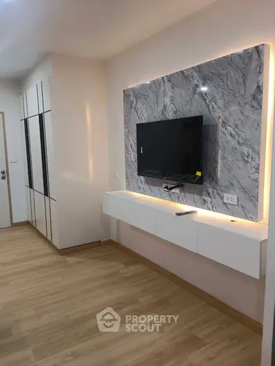 Modern living room with sleek TV wall unit and elegant wood flooring