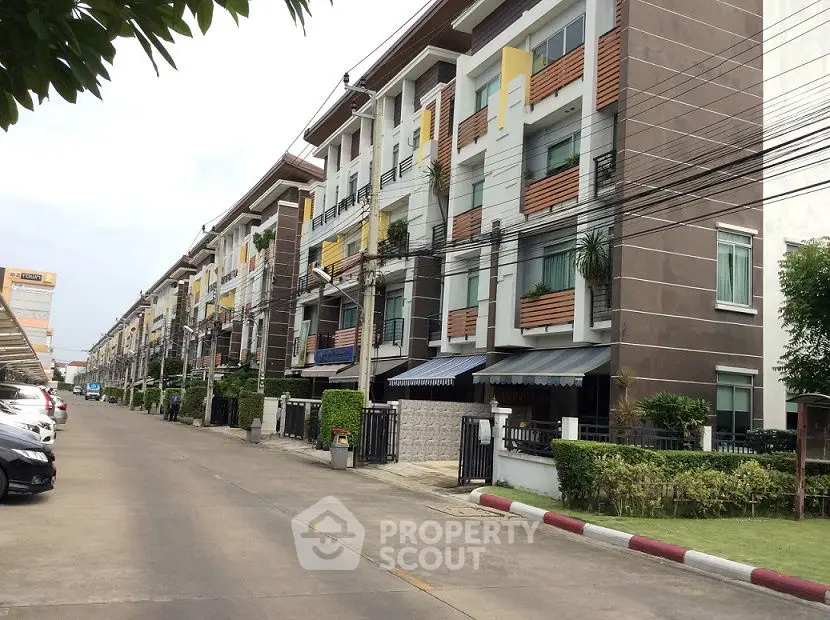 Modern townhouse complex with landscaped gardens and ample parking space.