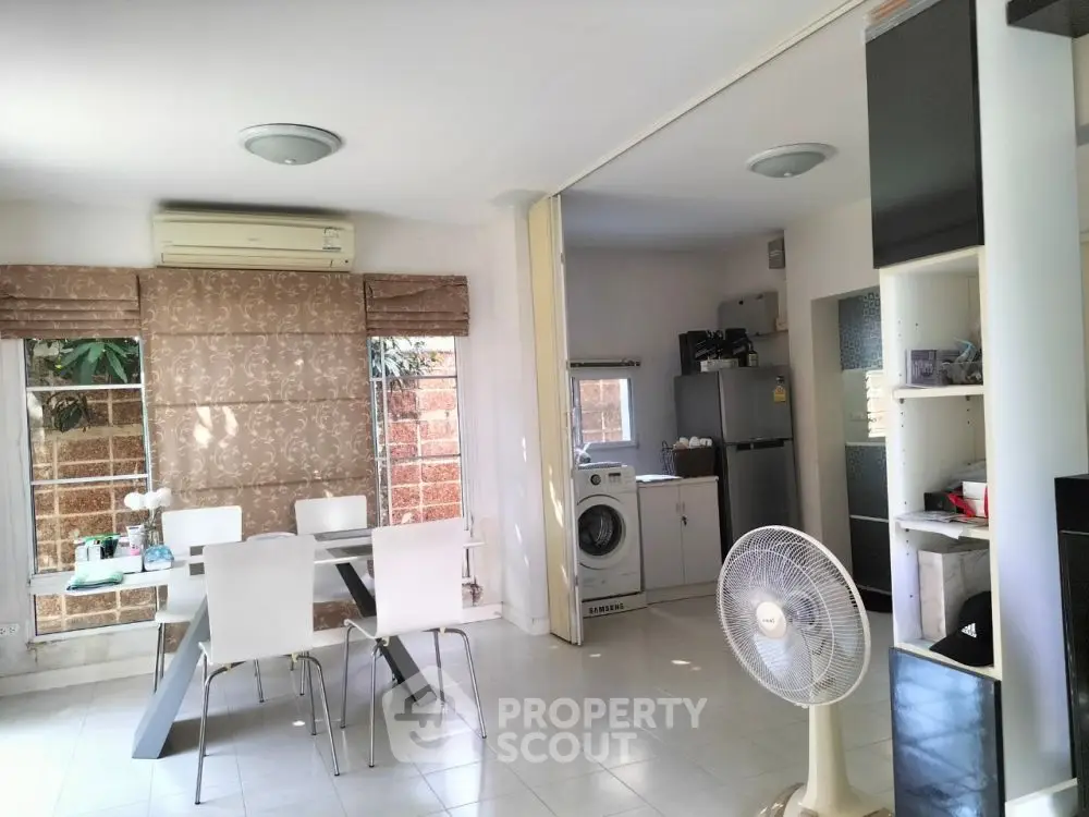 Modern dining area with washing machine and fridge in open layout kitchen