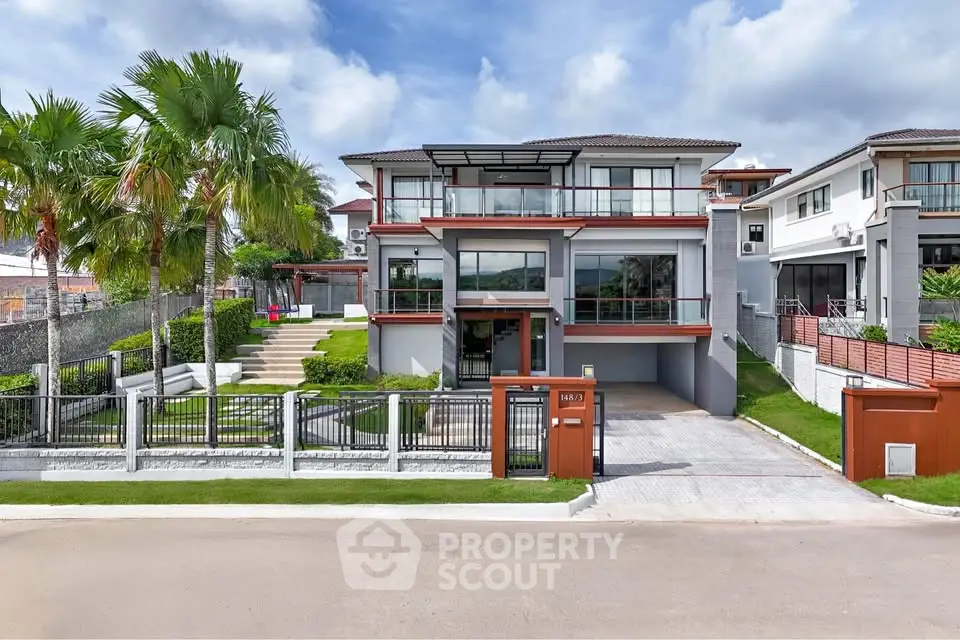 Luxurious modern house with landscaped garden and spacious driveway in a serene neighborhood.