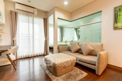 Modern living room with stylish furniture and large window for natural light.