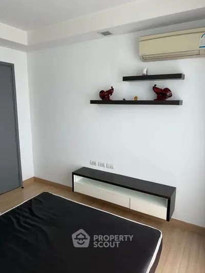 Modern minimalist bedroom with sleek furniture and air conditioning