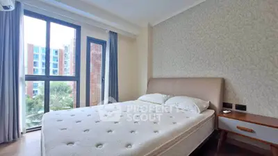 Bright and cozy bedroom with large window and modern decor in a stylish apartment.