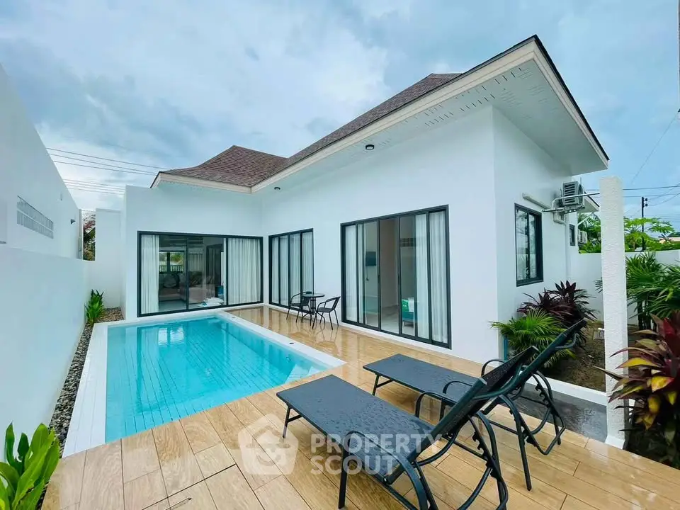 Modern villa with private pool and patio, featuring sleek design and lush landscaping.