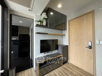 Modern apartment entrance with sleek TV setup and stylish decor