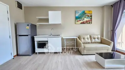 Modern living room with kitchenette and cozy seating area