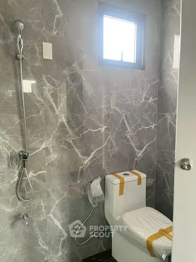 Modern bathroom with marble walls and sleek fixtures