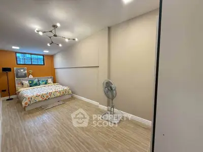 Spacious bedroom with modern lighting and stylish decor