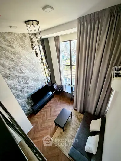 Stunning modern living room with high ceilings and city view, featuring elegant decor and ample natural light.