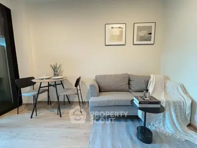 Modern living room with cozy sofa and dining area in stylish apartment.