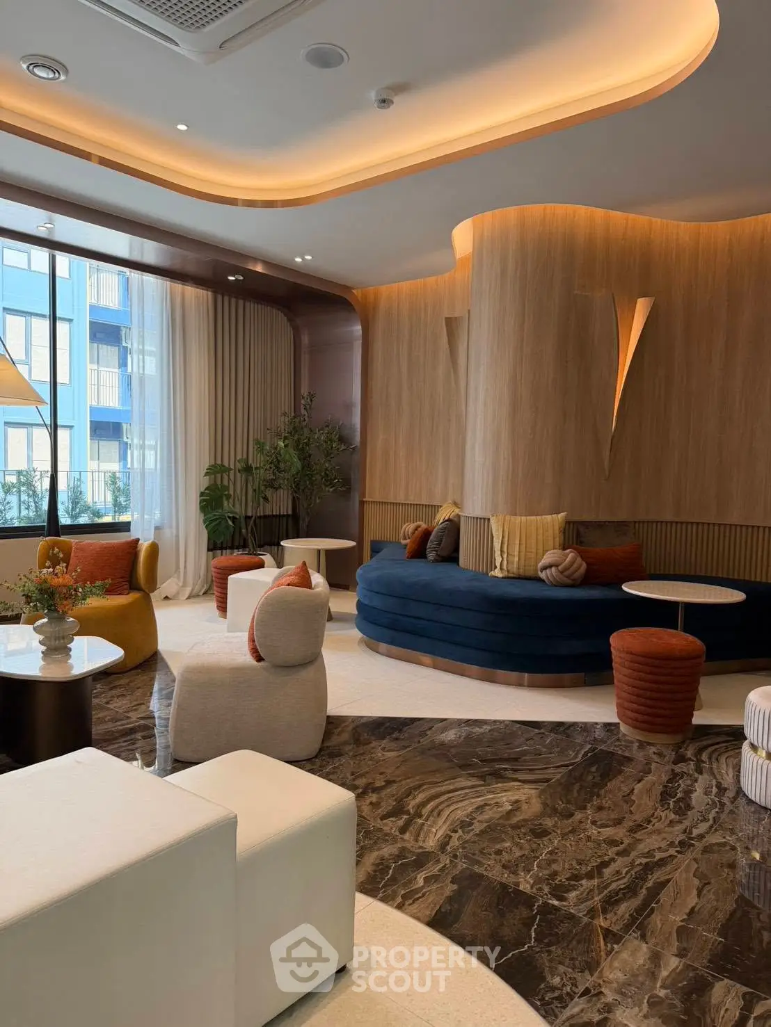 Luxurious modern living room with elegant furniture and stylish decor, featuring large windows and natural light.