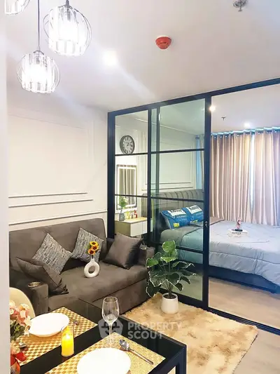 Modern open-layout living room with glass partition to bedroom, stylish decor, and cozy ambiance.