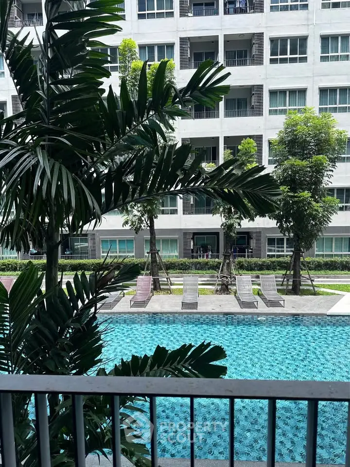 Luxurious apartment with pool view and lush greenery, perfect for relaxation and modern living.