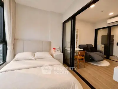 Modern bedroom with adjoining living area in a stylish apartment