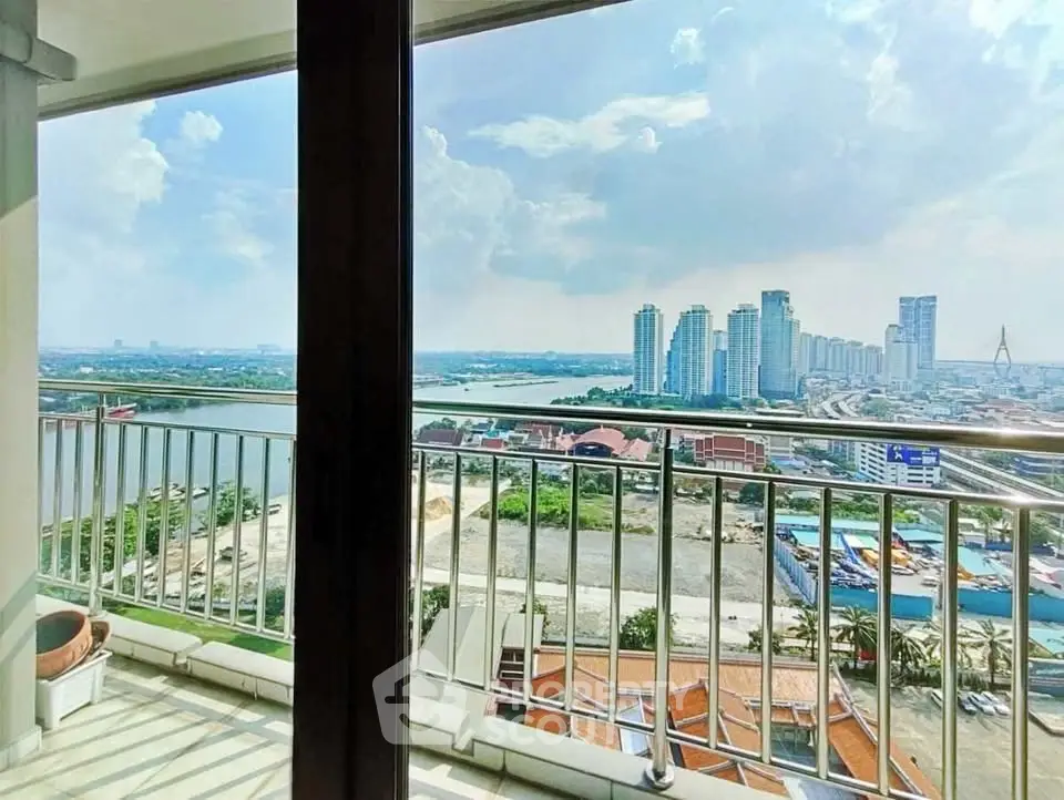 Stunning high-rise balcony view overlooking city skyline and river, perfect for urban living.