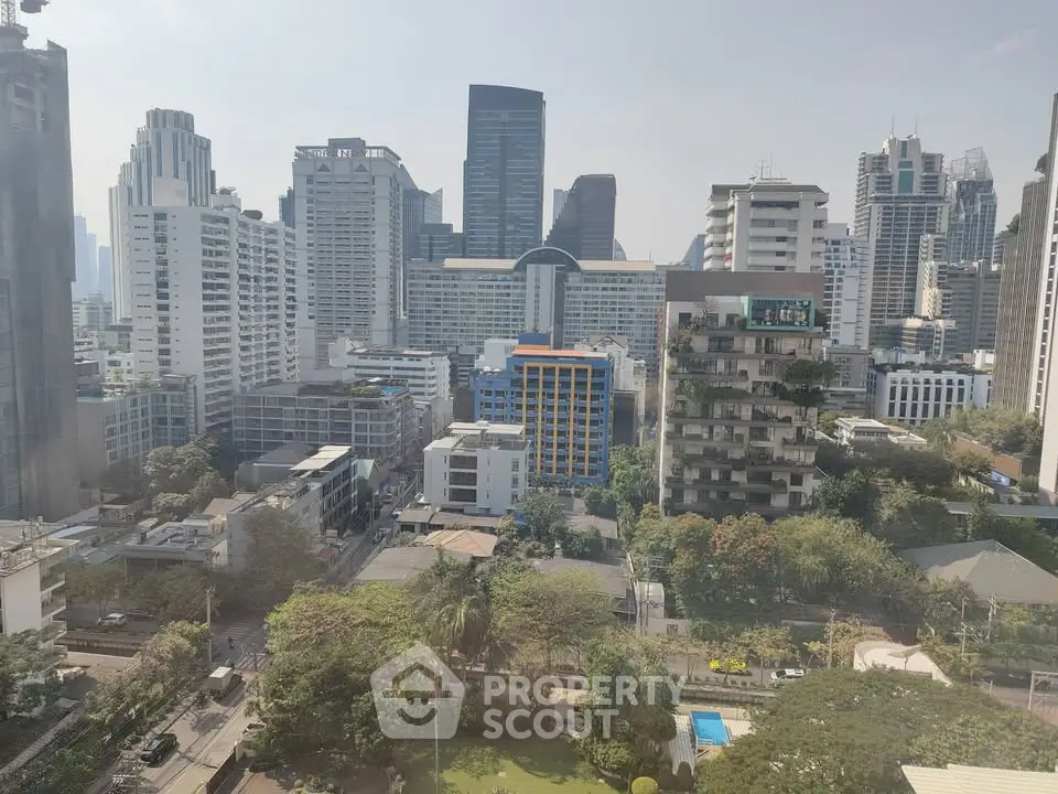Stunning cityscape view showcasing modern high-rise buildings and lush greenery in an urban setting.