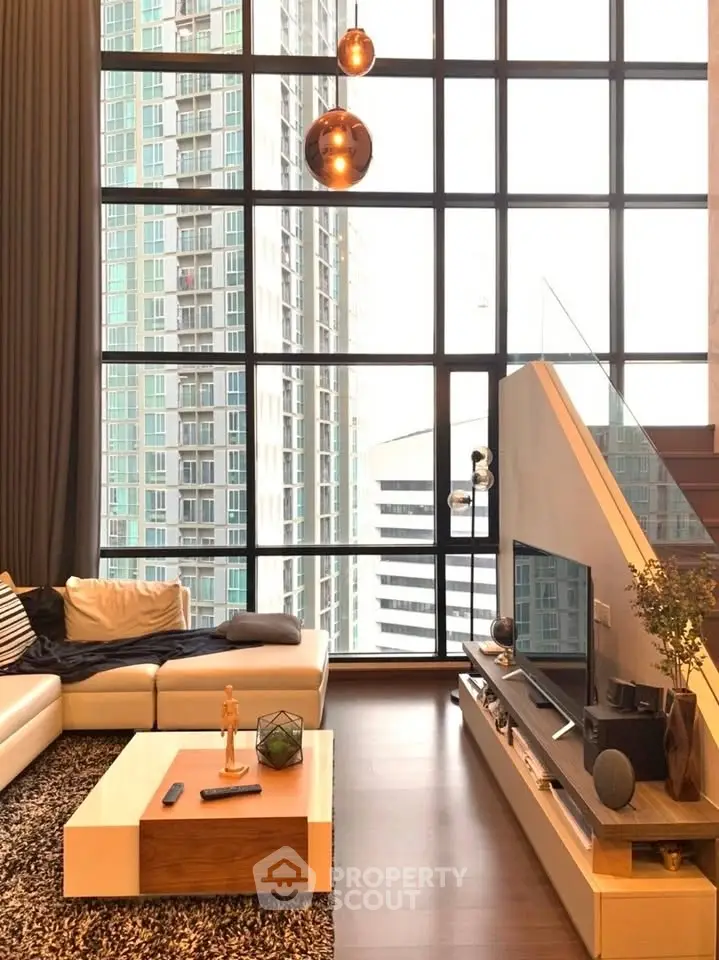 Luxurious modern living room with floor-to-ceiling windows and city view.