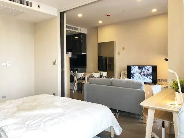 Modern open-plan living room with cozy bedroom and stylish furniture