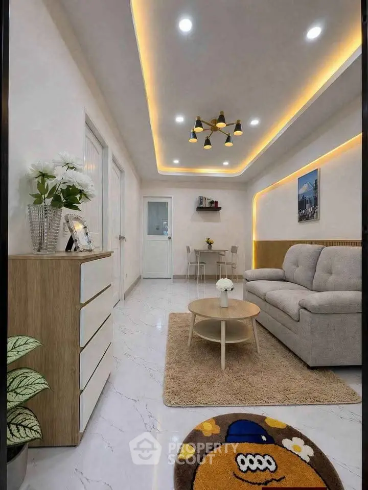 Modern living room with stylish lighting and cozy furniture, perfect for relaxation and entertaining.