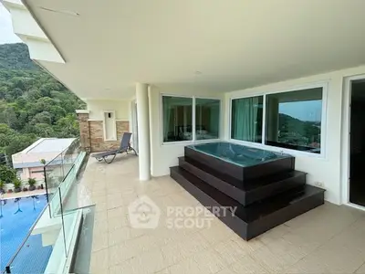 Luxurious balcony with jacuzzi and stunning mountain view in modern apartment