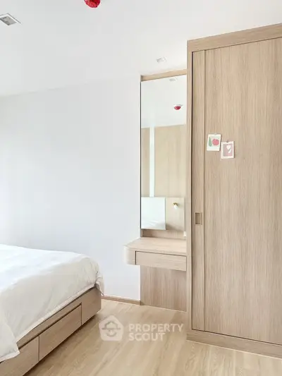Modern minimalist bedroom with wooden furniture and natural light