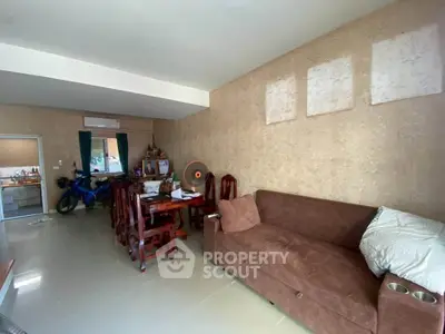 Spacious living room with elegant decor and dining area, perfect for family gatherings.