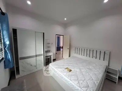 Spacious bedroom with modern furnishings and natural light