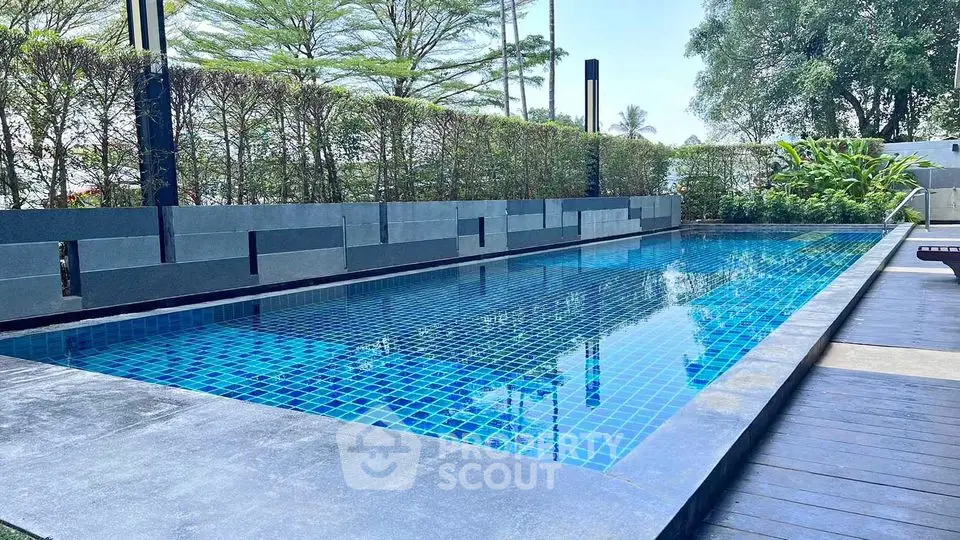 Luxurious outdoor swimming pool with modern design and lush greenery