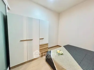 Modern bedroom with sleek wardrobe and cozy bed in minimalist design.