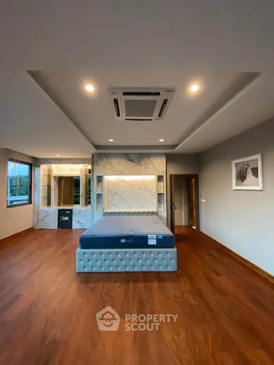 Luxurious bedroom with elegant wood flooring and stylish ceiling design