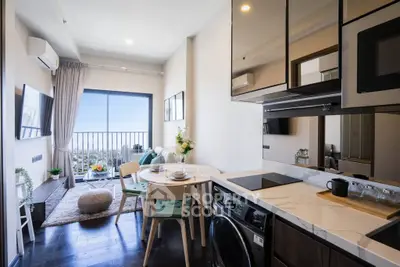 Modern open-plan kitchen and living room with balcony and city view