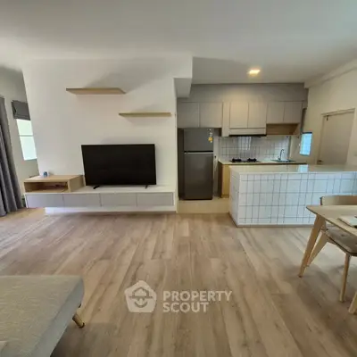 Modern open-plan living room with sleek kitchen and stylish decor