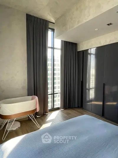 Modern bedroom with floor-to-ceiling windows and sleek wardrobe design