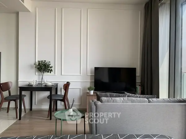 Modern living room with stylish decor and large windows for natural light.